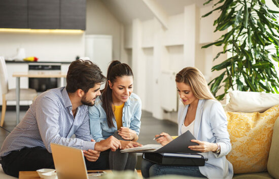 A female agent advising her clients.