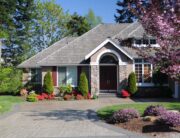 A beautiful home with tree flowers in bloom.