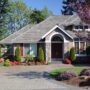 A beautiful home with tree flowers in bloom.